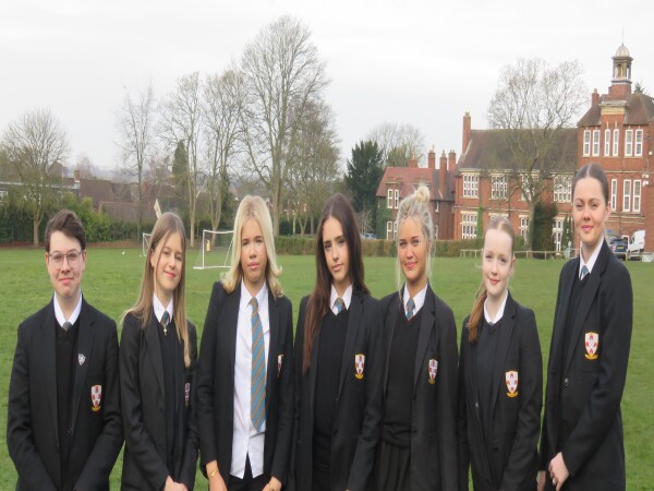 A photo of seven students standing outside 